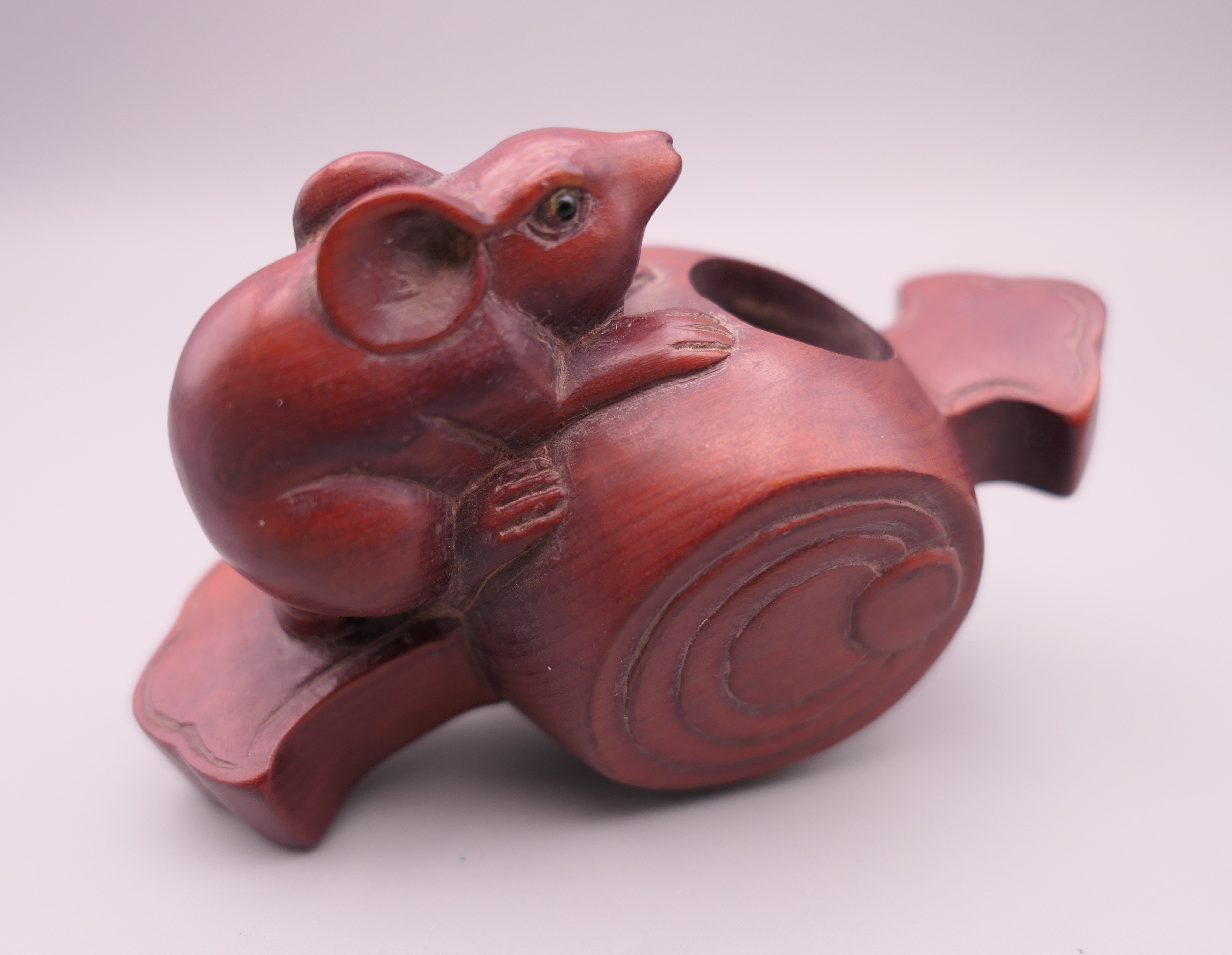A model of a rat on a barrel. 9.5 cm long.