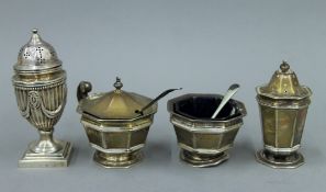 A silver three-piece cruet set and another silver pepper. The latter 10.5 cm high. 233.9 grammes.