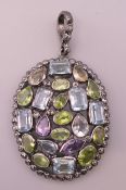 A silver peridot, diamond, amethyst and blue topaz pendant. 4 cm high excluding suspension loop.