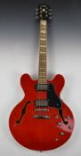 Indie semi acoustic jazz style guitar with candy red lacquered body