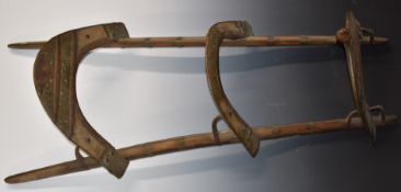 A 19th/20thC wooden dromedary camel saddle with engraved brass decoration and banding, L120cm