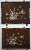 A pair of rosewood mother of pearl and abalone inlaid wall panels decorated with birds and