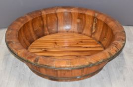 A large wooden bowl with brass banding, possibly yew / fruit wood, H22cm, 77cm diameter