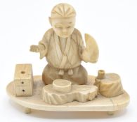 Japanese Meiji period ivory okimono depicting a man cooking, signed to base, H6cm