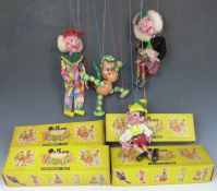 Four Pelham Puppets Baby Dragon, Pinnochio, Macboozle and Clown, all in original boxes.
