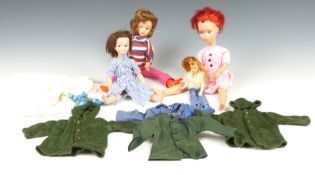 Four Sindy, Barbie and similar dolls together with various clothing and outfits, largest 31cm tall.