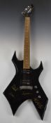 BC Rich Bronze range Warlock electric guitar the black lacquered body bearing signatures of the band
