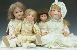 Four bisque headed dolls comprising two Heubach, one Schoenau & Hoffmeister and one Amand Marseille,