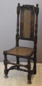 Charles II or William & Mary cane seated chair, with carved foliate crown or similar motif to top,