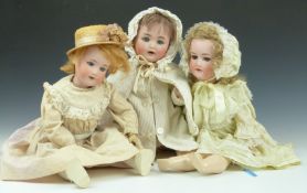 Three Armand Marseille and similar bisque headed dolls, one stamped 290, one 390 and the other