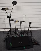 A collection of various microphone and guitar stands, drum stool etc