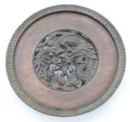 Chinese 19thC hardwood stand with carved and pierced decoration depicting a dragon, diameter 16.5cm