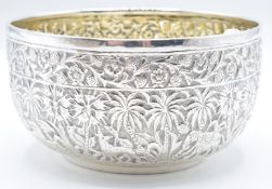Indian or Burmese silver bowl with embossed decoration of animals amongst palm trees, diameter 10cm,