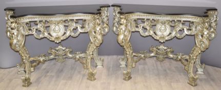 Pair of royalcore style silver coloured shaped console table with mask decoration and black marble