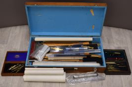 A large quantity of drawing equipment including boxwood rulers, slide rules, cased drawing sets,