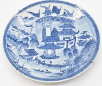Chinese 19thC blue and white charger decorated with buildings and boats outside a city or palace