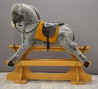 Merrythought rocking donkey with leather saddle on wooden base, 105cm long.