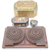 Indian carved hardwood folding adjustable booksafe together with three papier mache boxes, the