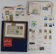 A blue springback stamp album containing GB and world stamps, a selection of GB first day covers and