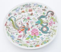 Chinese charger or shallow bowl with enamelled decoration of a dragon and phoenix surrounded by