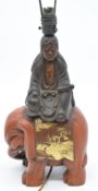 Japanese lacquer lamp in the form of a female figure atop an elephant with gilt decoration, H34cm
