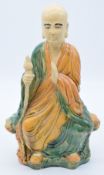 Chinese pottery polychrome figure of a monk, with impressed mark to base, H48cm