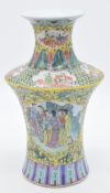 Chinese famille jaune vase of waisted form decorated to one side with ladies playing 'go', the other