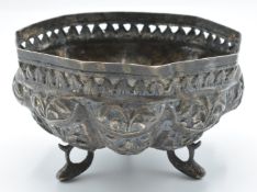 Indian or Burmese white metal bowl with embossed decoration, raised on three feet formed as fish,