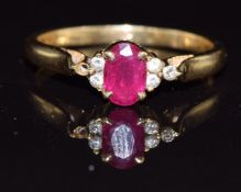 An 18ct gold ring set with an oval cut ruby and diamonds, 2.7g, size N