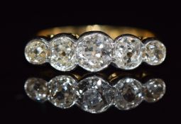 An 18ct gold ring set with five old cut diamonds, the largest 0.4ct and total diamond weight