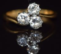 An 18ct gold ring set with three diamonds in a clover shaped platinum setting, 2.5g, size I