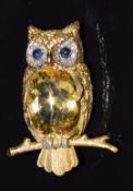 An 18ct gold brooch in the form of an owl set with an oval cut citrine, sapphires and diamonds eyes,