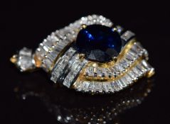 An 18ct gold metamorphic ring / pendant set with a round cut sapphire of approximately 2.2ct