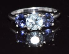 A 9k white gold ring set with a round cut topaz and iolite, 1.9g, size N