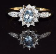 A 9ct gold ring set with an aquamarine and diamonds, 2.8g, size L/M