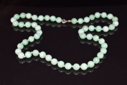 A necklace of jade beads, 67.8g, 56cm long