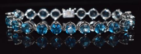 A 9k white gold bracelet set with London blue topaz total weight approximately 30cts, 18cm long,