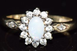 A 9ct gold ring set with an opal and cubic zirconia, 2.4g, size M