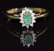 A 9ct gold ring set with an emerald and diamonds, 2.7,g, size M