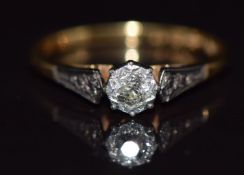 An 18ct gold ring set with a diamond in a platinum setting, 3.4g, size Q