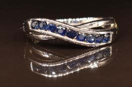A 9k white gold ring set with sapphires in a twist setting, 2.6g, size M