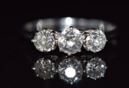 A platinum ring set with three diamonds, the centre diamond approximately 0.5ct, 3.2g, size R