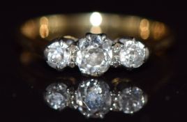 An 18ct gold ring set with three diamonds the centre diamond approximately 0.2ct, 2.2g ,size J