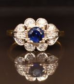 An 18ct gold ring set with a round cut sapphire and diamonds, 4.7g, size Q
