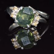 An 18ct white gold ring set with a tourmaline and white sapphires, 4.3g, size L