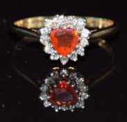A 9ct gold ring set with a heart cut fire opal surrounded by diamonds, 2g, size O