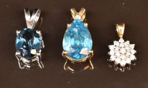 A 9ct white gold pendant set with blue topaz, a 9ct gold pendant set with diamonds and a 9k gold