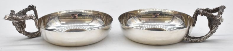 A pair of hallmarked silver tastevins with handles in the form of vines, London maker AE for Anthony