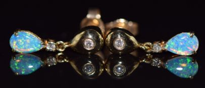 A pair of 14k gold earrings set with opals and diamonds