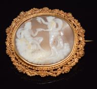 Victorian gilt brooch set with a cameo depicting a man, woman and bird, 5 x 4.3cm